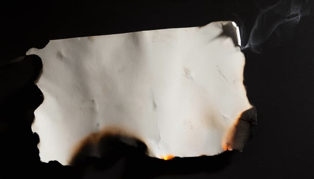A piece of paper with smoke coming out of it photo