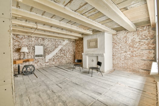 A room with a fireplace and a chair in it photo