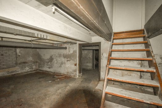 An empty room with a ladder and stairs photo