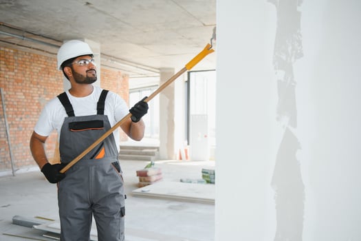 Indian Painter painting the office wall with roller paint photo