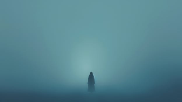 A lone person standing in the fog with a light photo