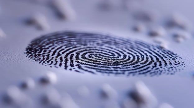 A fingerprint is shown on a white surface photo