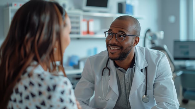 A smiling doctor talking to a patient photo