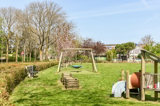 A grassy area with a swing set photo