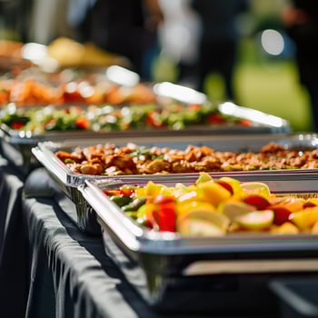 catered food at a corporate event, various dishes in chafing dishes under natural light photo