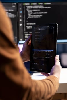 Teleworking programmer designing and developing software applications using tablet. IT administrator implementing and maintaining company systems using portable device, close up photo