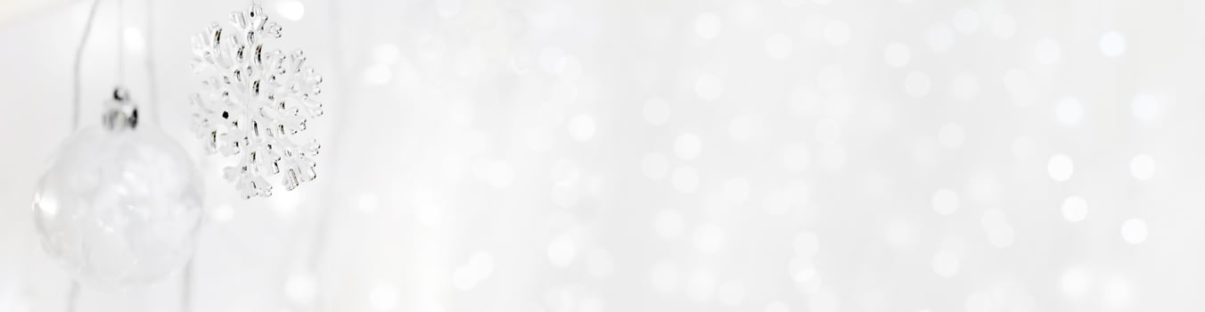 Transparent Christmas tree toy and snowflake on the background of garlands. Christmas background. Decorations for the Christmas tree. White background for new year. photo