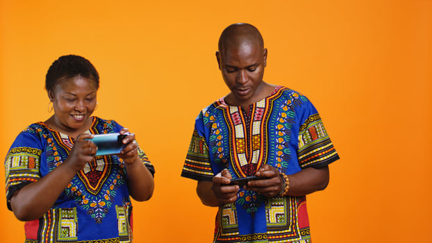 Cheerful woman winning videogames competition in studio, feeling happy about victory while she plays online with her husband. Young man feeling frustrated about losing to his girlfriend. photo