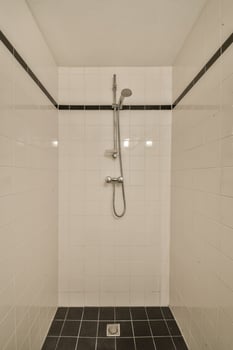 A shower with a shower head and a shower head photo