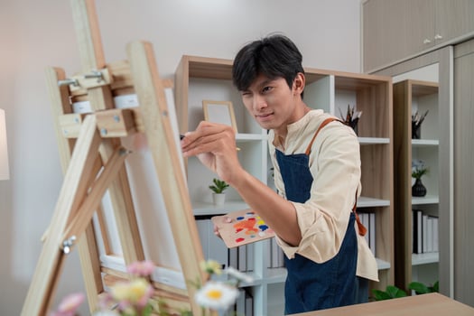 Focused artist painting at home studio easel photo