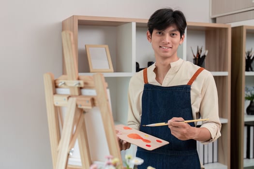 Young artist preparing canvas for painting in home studio photo
