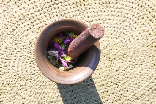 Medicinal herbs and flowers in a cooper mortar. photo