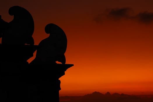 orange sky at dusk with cloud silhouettes photo