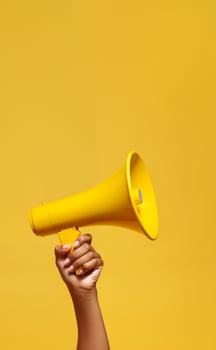 Yellow megaphone on a yellow back. photo
