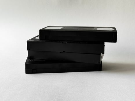 Retro nostalgia. stack of vintage vhs tapes against neutral background photo