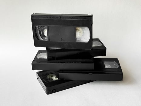Retro vhs tapes stack on white background. nostalgia and vintage media trend photo