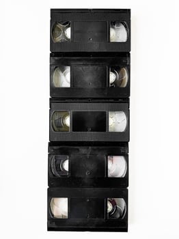 Vintage vhs cassettes stacked vertically on white background photo
