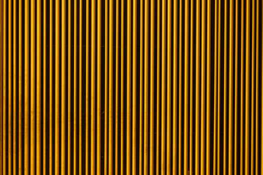 Wall decor. Golden rods decorate the wall. Abstraction of repair photo