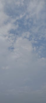 A man flying a kite in the sky photo