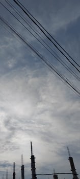 A plane flying over a city with power lines photo