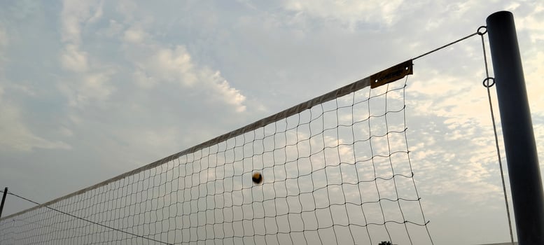 a volleyball net is in the air on a cloudy day photo