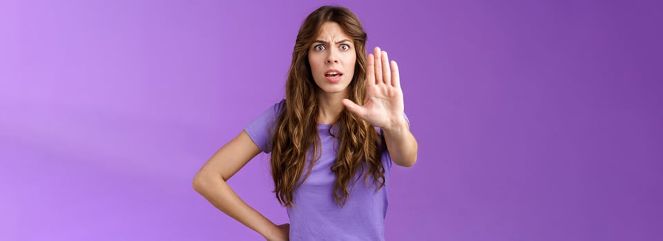 Serious-looking displeased assertive female friend stand confident demand stop smoking pull palm camera forbid disapproval gesture restrain you making bad choice purple background photo