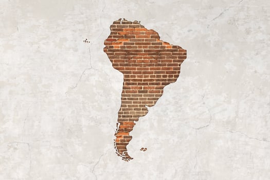 South America map on antique brick wall texture background. photo