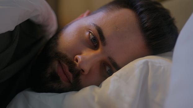 Caucasian man lying on bed trying sleep awake insomnia male guy late night bedroom home sleepless looking contemplation bedtime anxiety difficulty thinking disturbed sleeping problems worried medicine photo