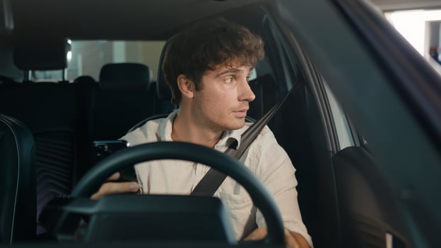 Tired puzzled upset worry anxiety Caucasian man driver male guy sit in car auto businessman frustrated thinking looking at window of automobile holding mobile phone stressed business problem bad news photo