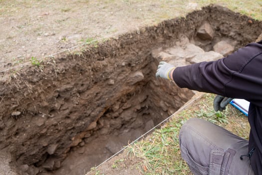 Selective focus, an archaeologist explaining an archaeological excavation. Archeological dig photo