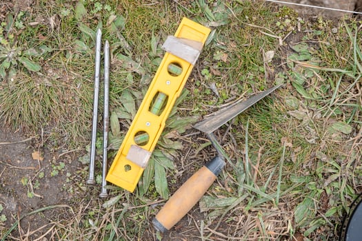 tools in an archaeological excavation, nails, hand level and trowel. Work tools photo