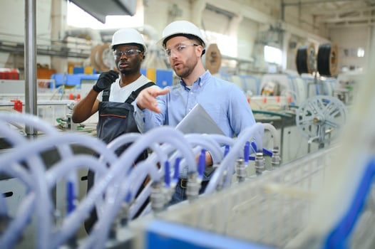 Two Heavy Industry Engineers Stand in Factory photo