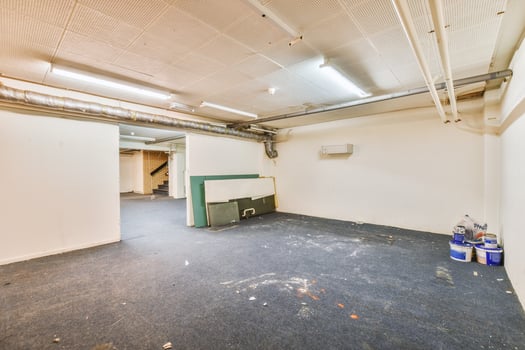 A large empty room with a lot of debris photo