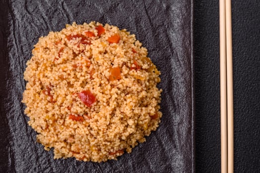 Delicious hot boiled wheat porridge couscous with vegetables f photo