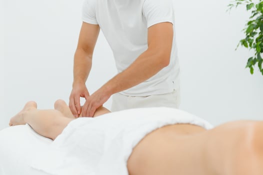 Massage therapist doing foot massage of patient photo