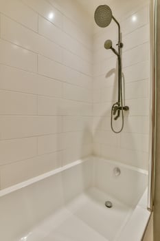 A white bath tub with a shower head photo