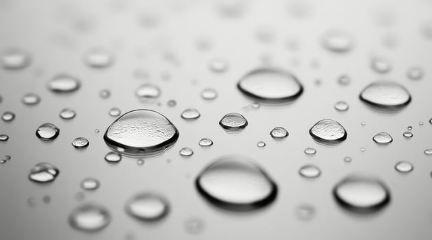 Close-up of raindrops on a smooth surface highlighting nature's delicate beauty during a rainy day photo
