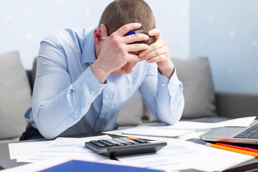 Distressed man sit at desk paying bills feel stressed having financial problems photo
