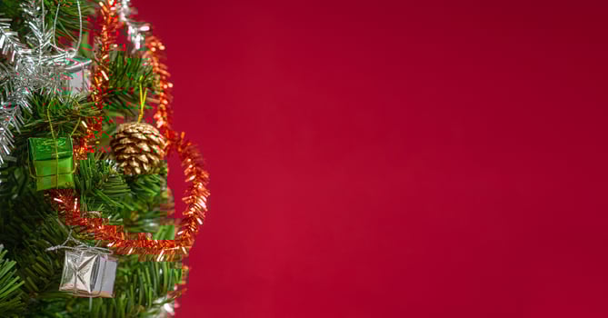 Part of Christmas tree over a red background with copy space for text photo