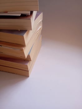photo of a stack of books that have started to yellow