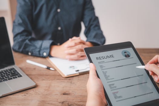 HR managers are interviewing job applicants who fill out their resume on the job application form in order to consider accepting a job as a company photo