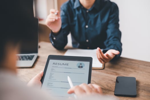 HR managers are interviewing job applicants who fill out their resume on the job application form in order to consider accepting a job as a company photo