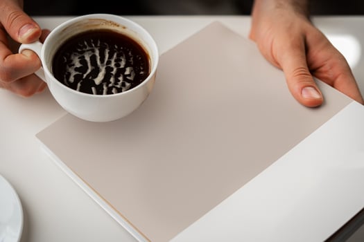 Man Reading Page of Magazine While Holding Coffee Cup photo