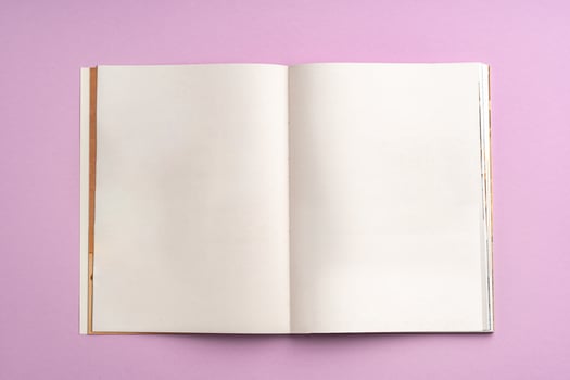 view of notebook with blank pages on a pink background photo