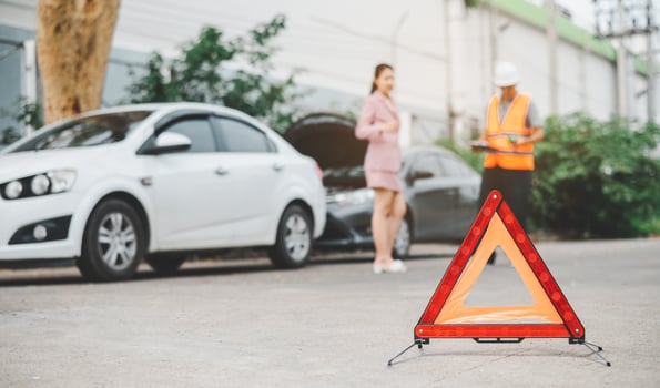 red emergency triangle on the road indicates that there is an accident or car breakdown on the road ahead. photo