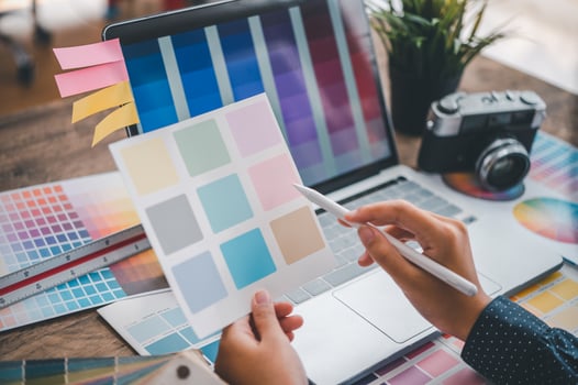 Graphic designer architects who work with laptops and color comparison tables for design work. photo