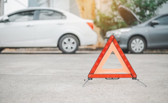red emergency triangle on the road indicates that there is an accident or car breakdown on the road ahead. photo