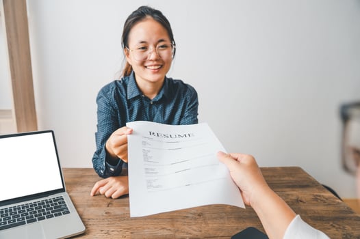 HR managers are interviewing job applicants who fill out their resume on the job application form in order to consider accepting a job as a company photo