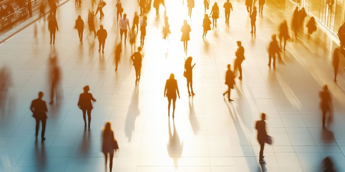 Silhouetted crowd in motion under warm sunset light photo