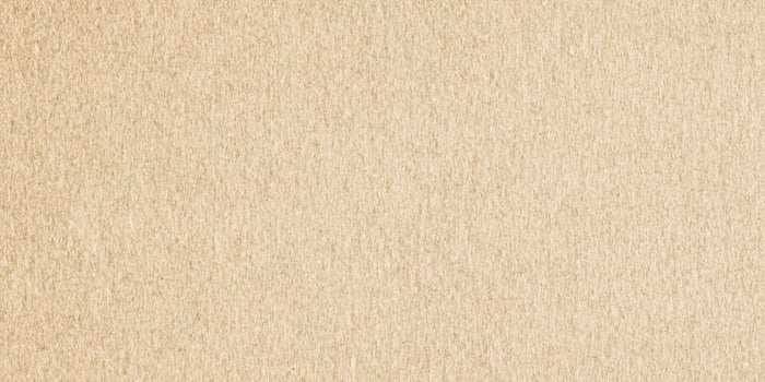 Close-up of textured light brown paper background for creative designs photo